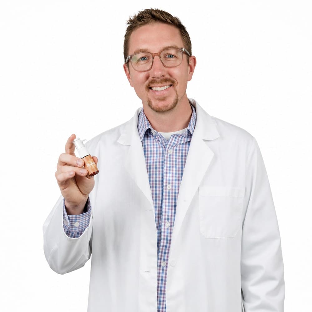 Dr. Casey Fisher, founder of Dr.Drop, holding an allergy-drop bottle